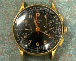 vintage Junghans Meister Telemeter chronograph wristwatch with a black dial and goldplated case