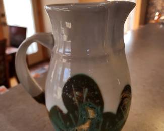 Pottery pitcher signed