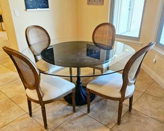 Restoration Hardware round table with glass top. Restoration Hardware chairs are sold separate. We have five of these chairs one not pictured