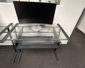 Modern glass-top computer desk with a durable black steel frame and sliding keyboard tray. Stylish, minimal, and perfect for home offices, studios, or workspaces. This is a used desk in good overall shape — solid, stable, and clean. Only light cosmetic wear from normal use. I bought this for $499.  amiable 2 desks, yours for $75.00 each 