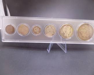 Lot 37. Type set including 1880 O Morgan Silver Dollar, Barber Half, Quarter and Dime, V Nickel and an Indian Head Penny