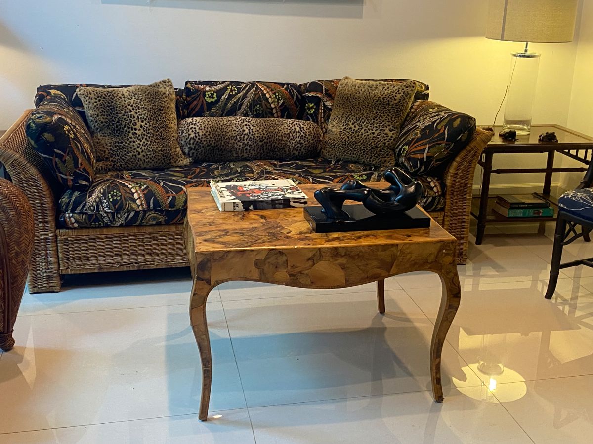 Italian Burlwood table 
Leopard pillows 
Cuban sculpture 
Wicker sofa 
