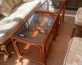 Pair of glass top tables rattan w bottom shelf 