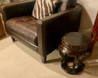 Large leather armchair 
Antique side asian table/stool 
Zebra cushion 