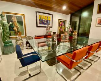 6 orange  chrome armchairs 
2 blue chrome armchairs 
Large glass top dining table 
Decorative vases 
Tall lady Asian sculptures 2 
Large wood Asian ladies 