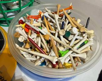 Bucket of assorted golf tees