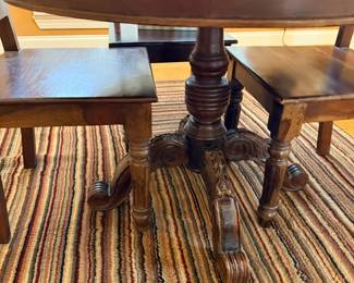 Dark wood side table with turned legs and lower shelf