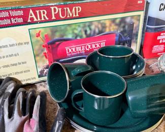 Camping gear, air pump, green enamelware cups and plates