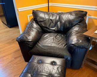 Black leather sectional sofa with ottoman