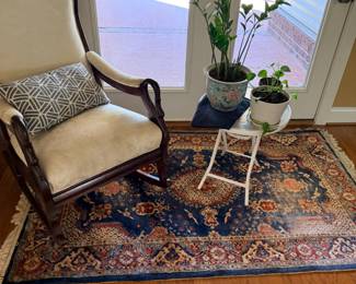 Sitting area with armchairs, houseplants, Persian area rug