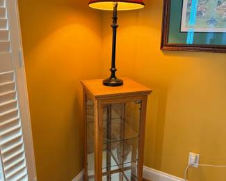 Table lamp with red shade on wooden plant stand