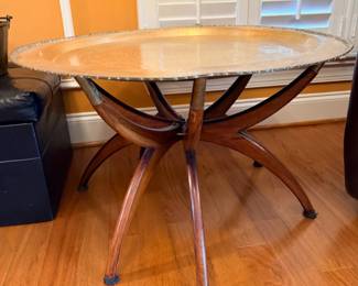 Round glass-top accent table with curved legs