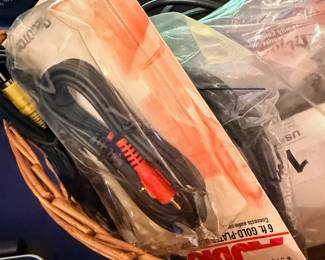 Basket of assorted cables, tools, and electronics accessories
