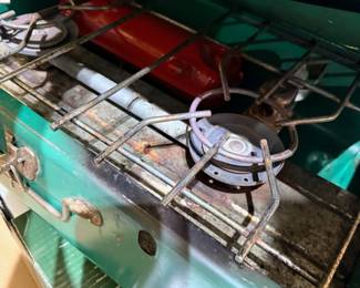 Vintage Coleman camp stove in green metal case
