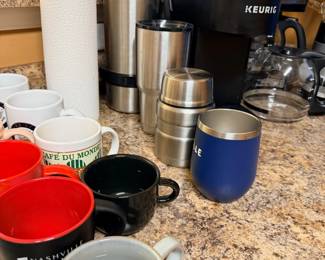 Keurig coffee maker, assorted coffee mugs, kitchen items