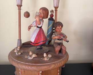 Thorens Carved Wooden Figurine Made in Switzerland 1960s/70s Thorens movement wood carved “Santa Lucia” sculpture. Stamped “Anri”. Depicts little boy playing the banjo and girl dancing while white birds tweet around them. Beautifully made Swiss authentic collectors piece.