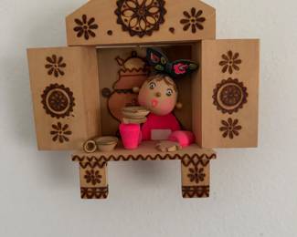 a vintage Russian hand-crafted wooden wall decoration featuring pyrography details, decorative shutters, and a scene from the Kolobok fairytale. 