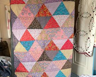 a handmade patchwork quilt made of triangles