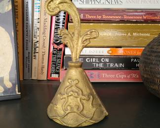 decorative brass bell featuring a Victorian-style design and an ornate handle