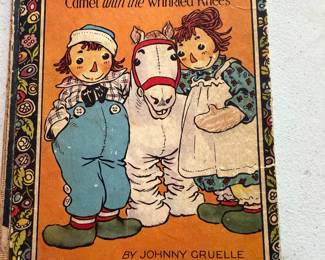 vintage book is titled "Raggedy Ann and Andy and the Camel with the Wrinkled Knees" by Johnny Gruelle. 