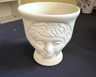 vintage ceramic face vase features a stylized, matte white embossed head