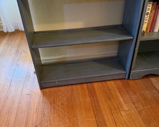 a blue wooden bookcase