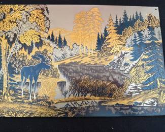 Soviet-era steel wall plaque featuring a decorative landscape scene of a moose in a wilderness setting, manufactured in the USSR by the Zlatoust factory. 
