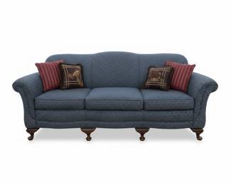 Blue Upholstered Sofa with Decorative Pillows and Ball-and-Claw Feet