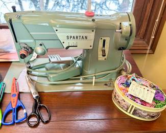 Vintage singer Spartan sewing machine with cabinet.