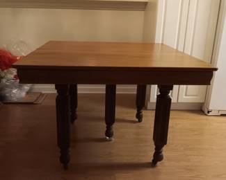 Antique farm house 5 leg table 42" square, 5 leaves & pads, nice antique table, good condition, has 4 leaves that measure 9.5" and one leaf that measures 9".  When all the leaves are in the table, it measures 42"x 89".  The table is ash or poplar and probably originally had a painted on grain which looked like oak but has been refinished.  $150.