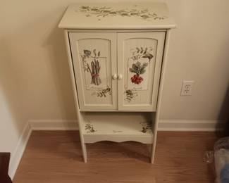 Cute small painted cupboard, measures 36" tall, 19" wide, 12" deep.  Has kitchen theme painting of asparagus, vegetables and radishes. Lightweight probably made in China, good condition $50.
