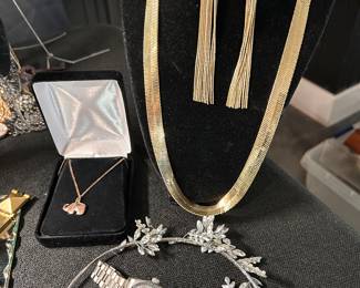 tiara, gold necklace and earrings