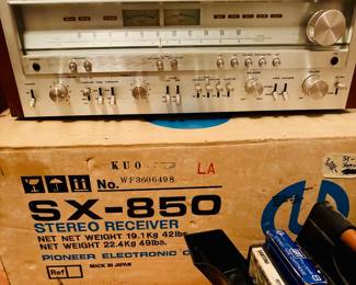 vintage Pioneer SX-850 stereo receiver, a highly sought-after collectible from the 1970s "golden age of hi-fi".  Audio Power: It delivers 65 watts per channel into 8 ohms.  Features: It features a silver-faced brushed aluminum front panel, analog tuning meters, and a walnut veneer cabinet. 