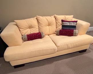 Pale Yellow Upholstered Sofa with Decorative Pillows