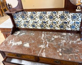 Victorian marble top washstand with detailed tiled backsplash
