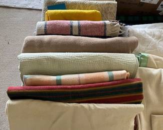 Blankets, quilts and an assortment of linens