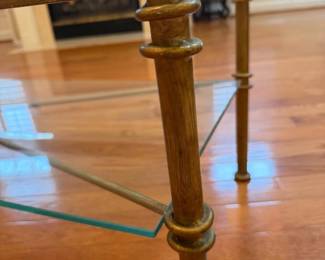 Glass coffee table with solid metal frame and two-tier design. Clean, classic look and very sturdy. Details: • Size: 50” L x 25” W x 18” H • Heavy glass top and lower shelf • No cracks or chips • Normal cosmetic wear on frame (see photos)