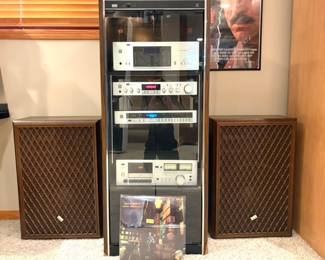  A vintage Sansui stereo system with a component rack, receiver, and large speakers, 