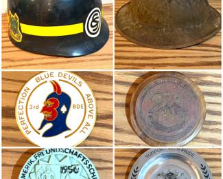 A vintage military helmet liner, a collection of military coins including a 3rd Brigade, 1st Armored Division ("Blue Devils") unit insignia coin, and a vintage German shooting medal. Also, a vintage WWI US Army M1917 "Doughboy" helmet and a vintage United States Air Force challenge coin Strategic Air Command pewter tray.