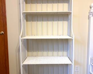 A white wicker and metal baker's rack. 