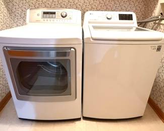 A  pair of LG top-load washer and electric dryer. 