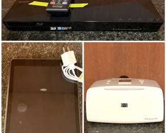 Sony BDP-S1100 Blu-ray Disc Player, Apple iPad, and a HP Photosmart 325 Compact Photo Printer. 