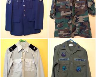 A collection of military uniforms including a vintage United States Air Force uniform, a vintage United States Air Force (USAF) long-sleeve dress shirt, a vintage US Army Woodland camouflage Battle Dress Uniform (BDU) jacket and a vintage U.S. Air Force OG-107 or OG-507 utility shirt.