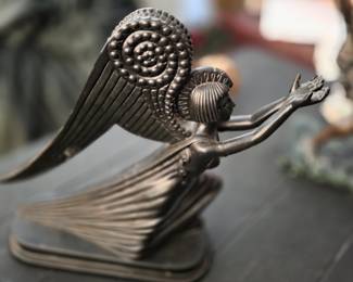 "Angel," created by the renowned Art Deco artist Erté (Romain de Tirtoff). 
Design: Features a Neoclassical style female figure with stylized geometric wings and draped robes. -not bronze