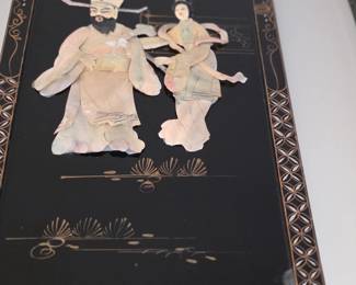 
This item is a vintage Asian wall panel, often crafted with mother-of-pearl or soapstone inlay on a black lacquered wood background, commonly depicting traditional scenes or figures. 