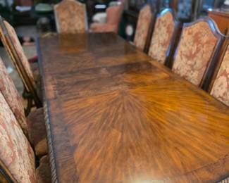 This item appears to be a Maitland Smith Chippendale-style dining table, possibly in a mahogany finish. The table features a decorative flamed wood veneer top and carved rope-edge detailing. 