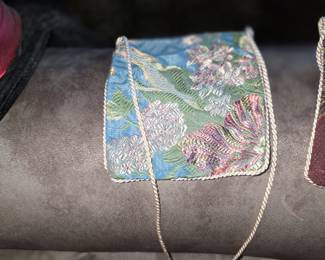 appears to be a petit point needlepoint tapestry bag. 