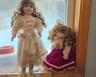 porcelain dolls, likely produced by brands such as Heritage Mint Ltd or similar manufacturers known for Victorian-style costumes, hand-painted features, and bisque porcelain components. 