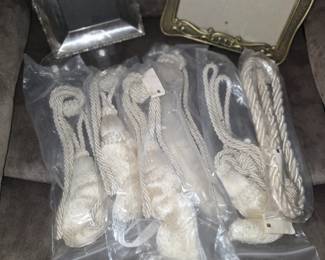 decorative drapery tiebacks feature twisted ropes and tassels. 