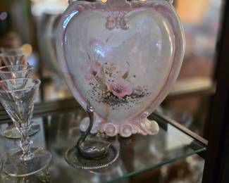 This item appears to be a vintage, heart-shaped ceramic vase featuring a pearlescent finish and floral decorations. 